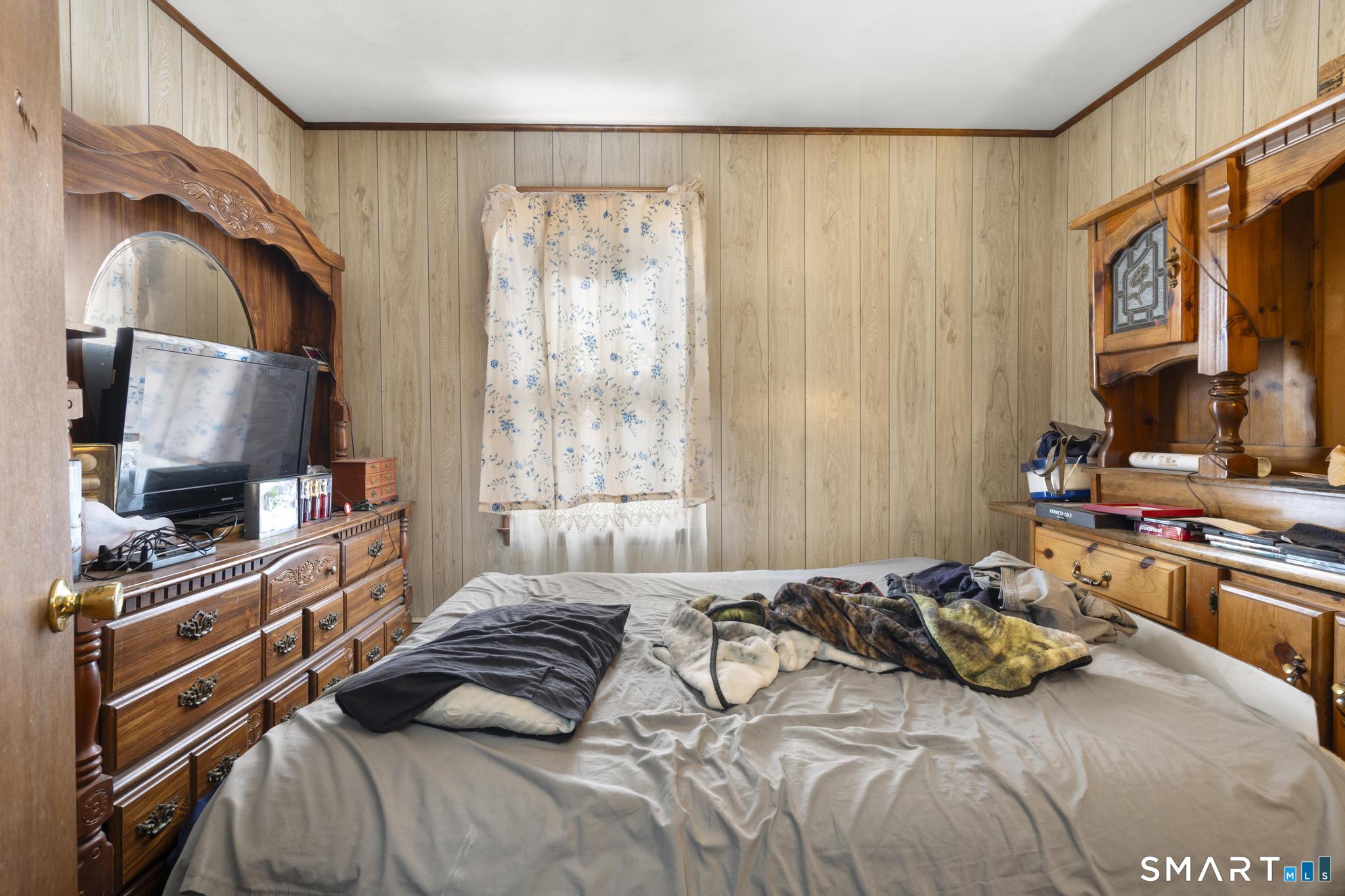 23 North First Street Meriden, CT 06451 - Photo 12 of 29 a bedroom with a bed and a flat tv screen