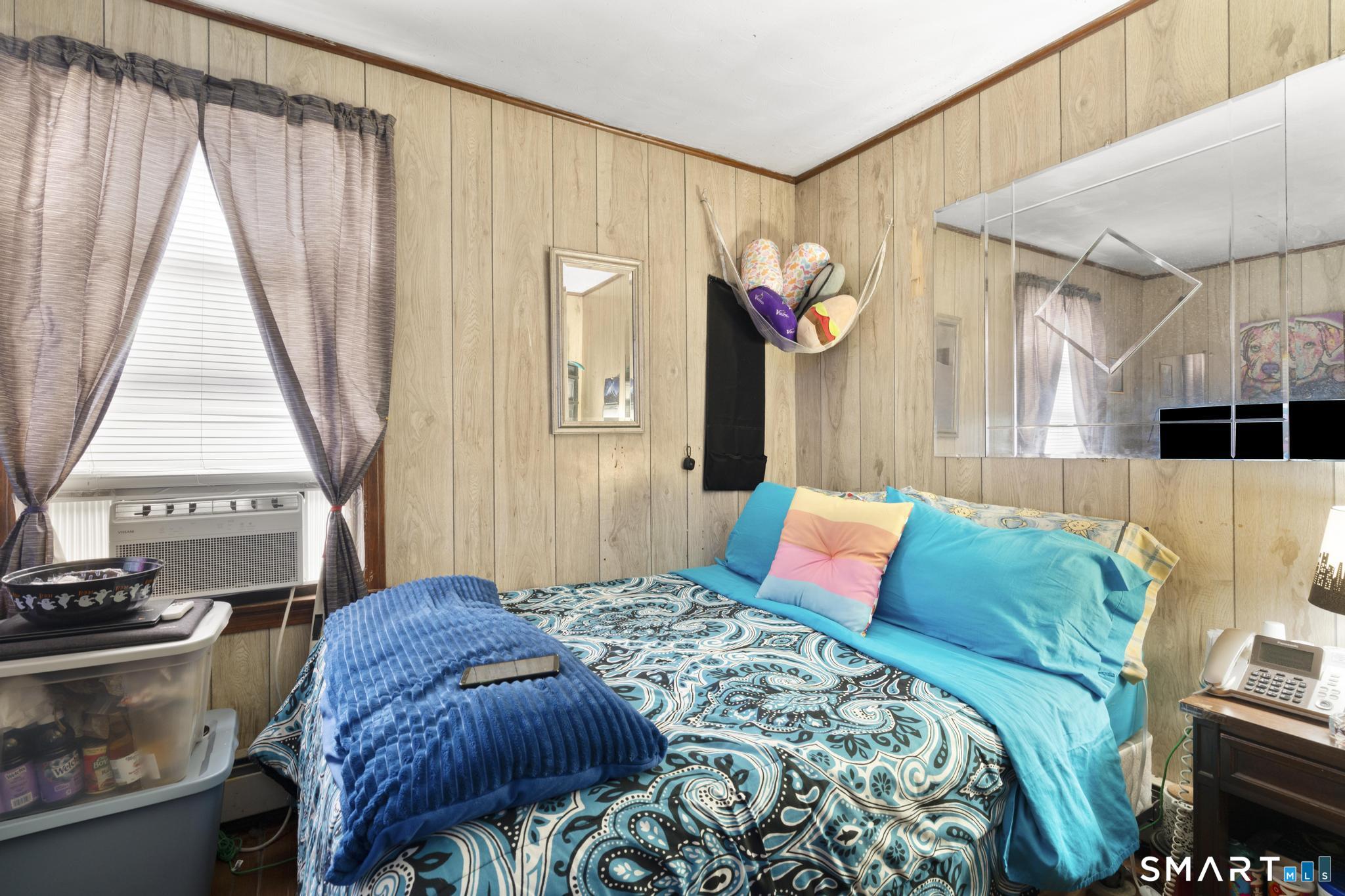 23 North First Street Meriden, CT 06451 - Photo 15 of 29 a bedroom with a bed a dresser and a large window