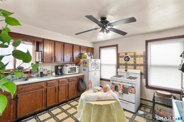 a kitchen with a sink appliances and cabinets