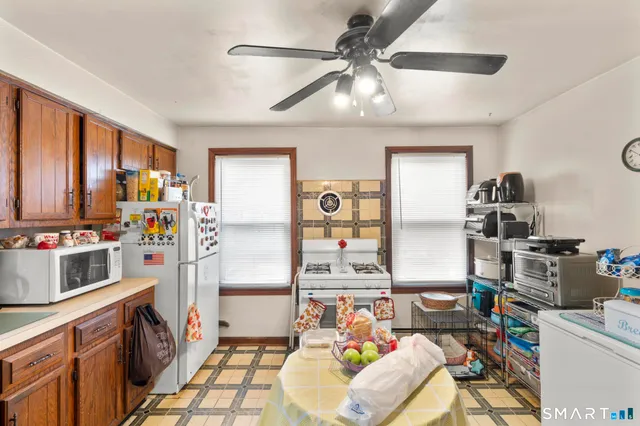 a kitchen with stainless steel appliances kitchen island granite countertop a refrigerator and a stove