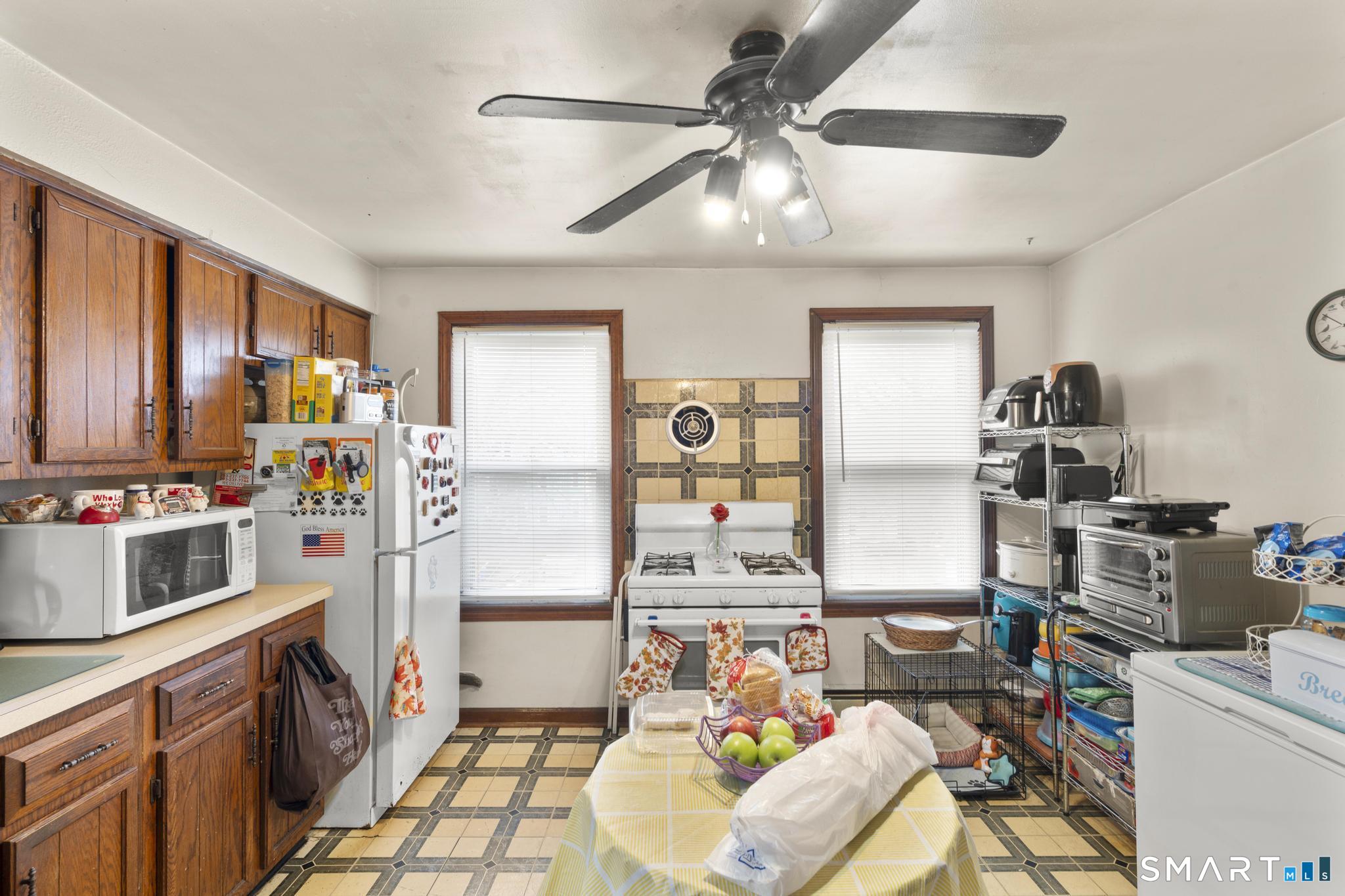 23 North First Street Meriden, CT 06451 - Photo 17 of 29 a kitchen with stainless steel appliances kitchen island granite countertop a refrigerator and a stove