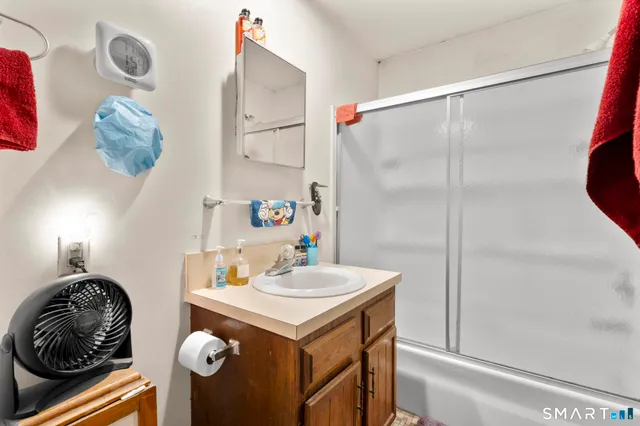 a bathroom with a sink vanity and mirror