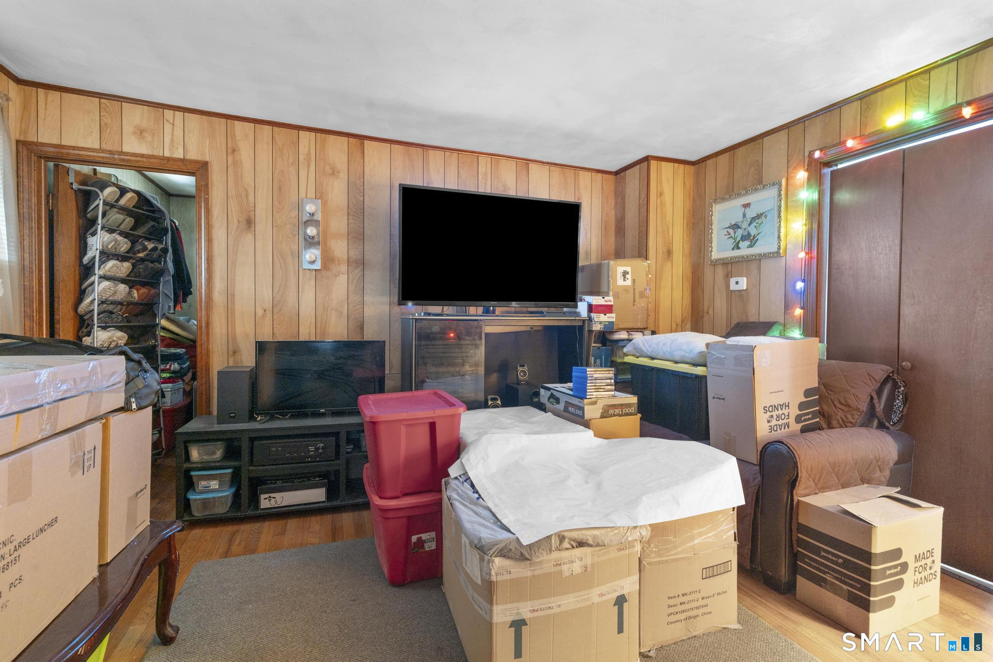 23 North First Street Meriden, CT 06451 - Photo 22 of 29 a living room with furniture a flat screen tv and a floor to ceiling window
