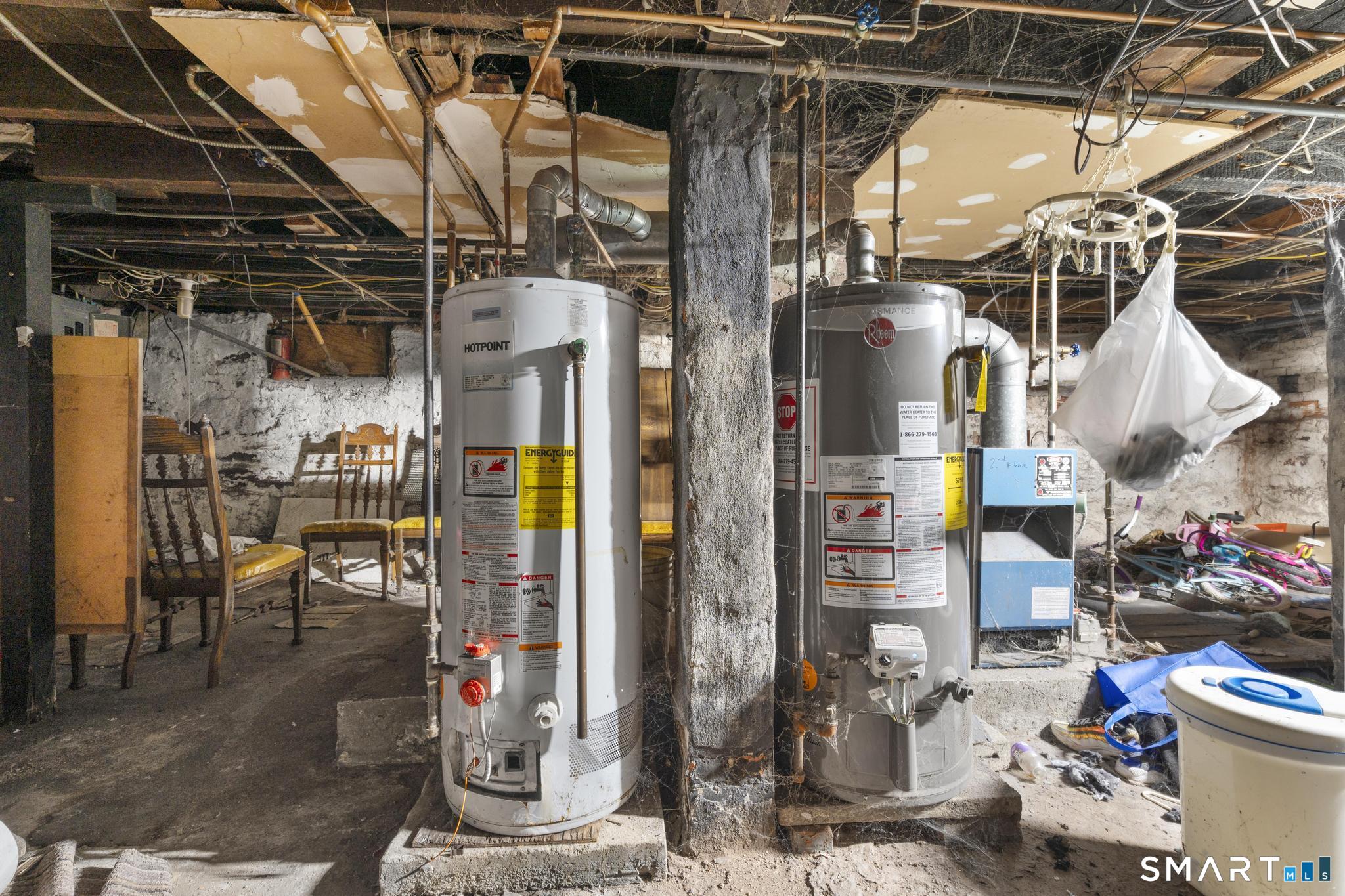23 North First Street Meriden, CT 06451 - Photo 26 of 29 a view of a storage room with water heater and chairs