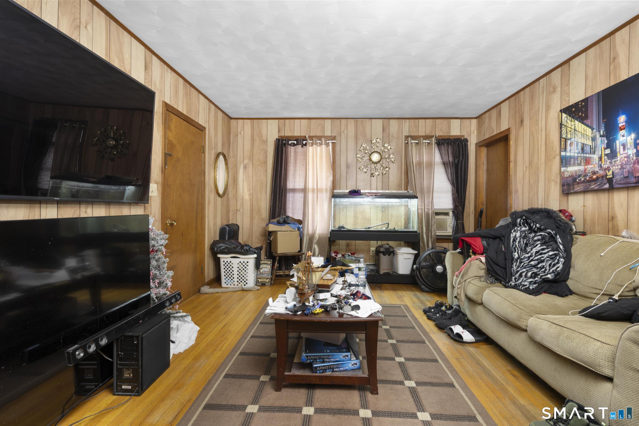 23 North First Street Meriden, CT 06451 - Photo 5 of 29 a living room with furniture and a flat screen tv