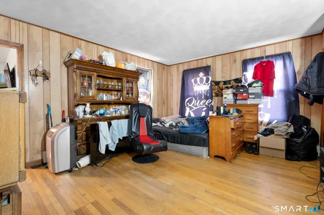 a view of a livingroom with workspace and a window