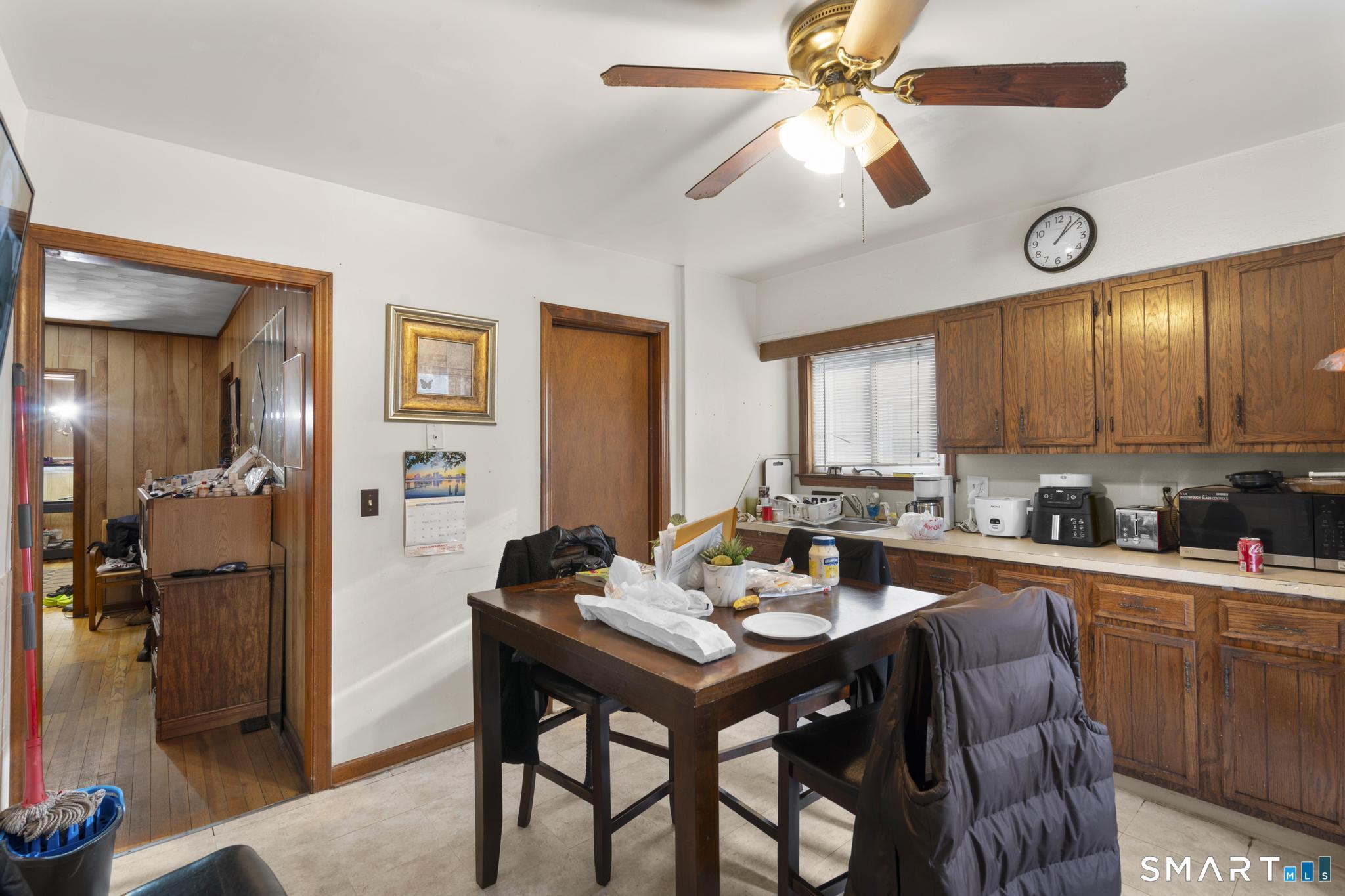 23 North First Street Meriden, CT 06451 - Photo 8 of 29 a kitchen with a dining table and chairs