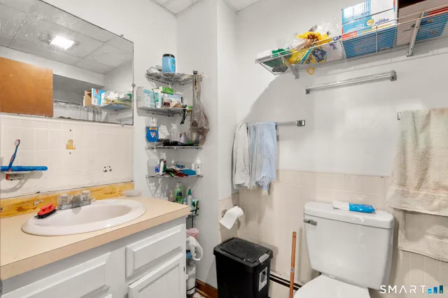 a bathroom with a sink a toilet and a shower curtain