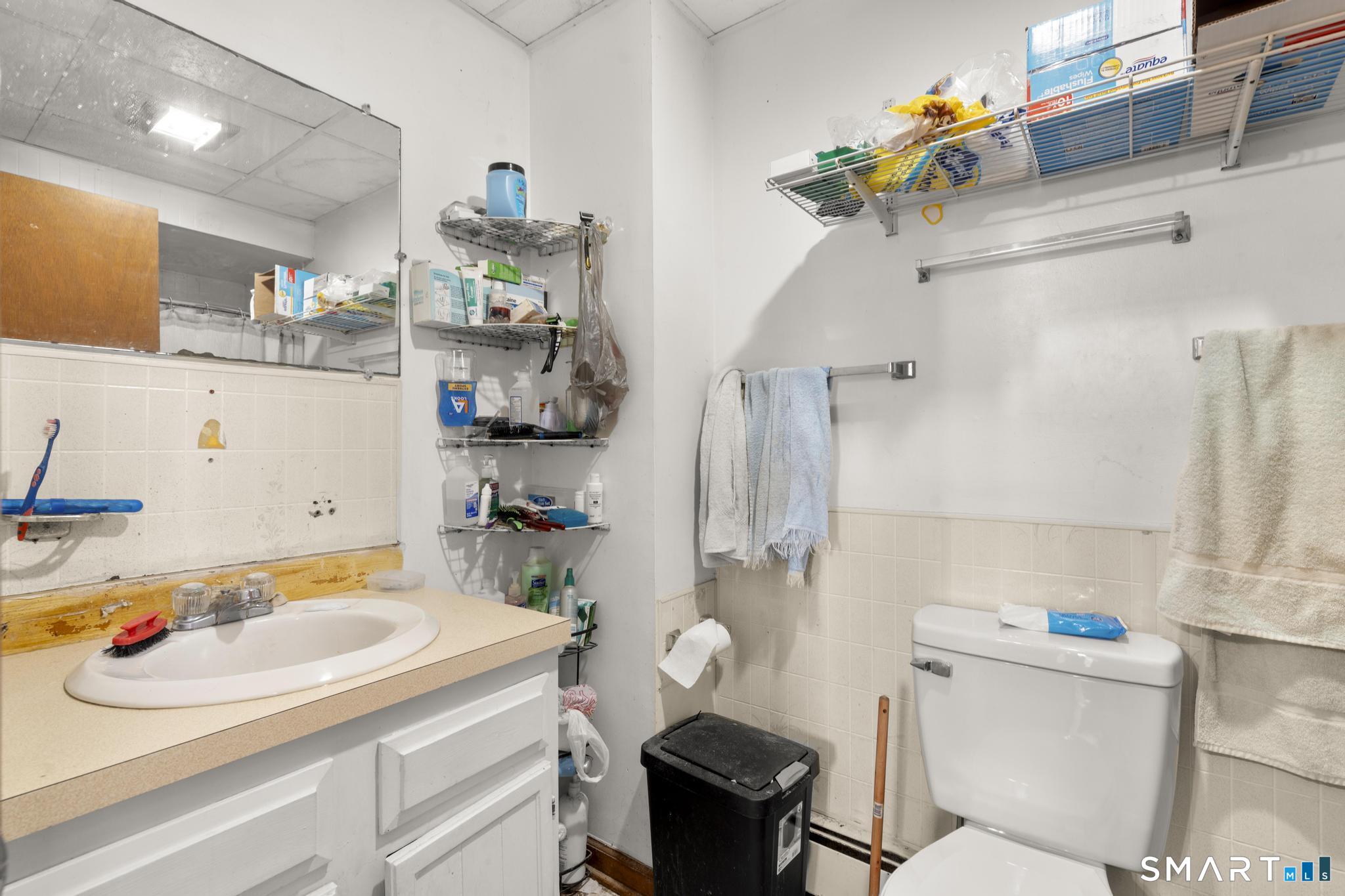 23 North First Street Meriden, CT 06451 - Photo 10 of 29 a bathroom with a sink a toilet and a shower curtain