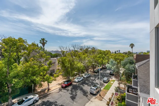 an aerial view of a residential houses with yard