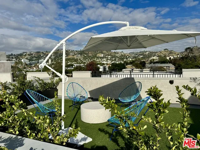 a view of a chairs and table in backyard