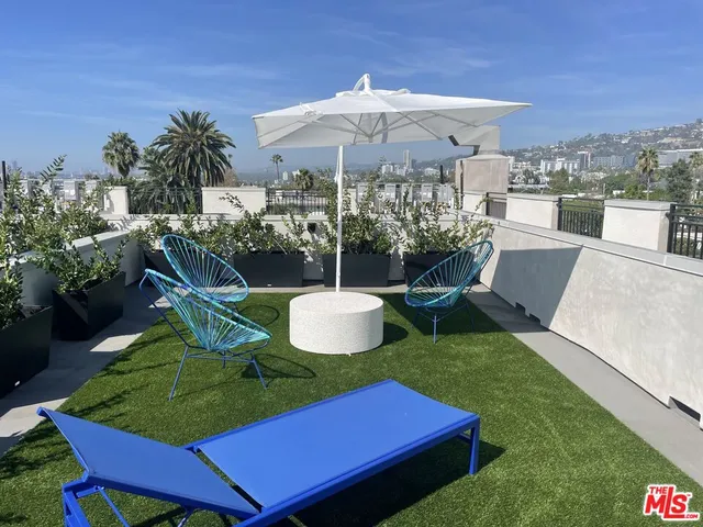 a view of an chairs and table in patio
