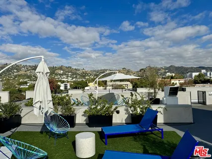 a view of a city with lawn chairs and a yard