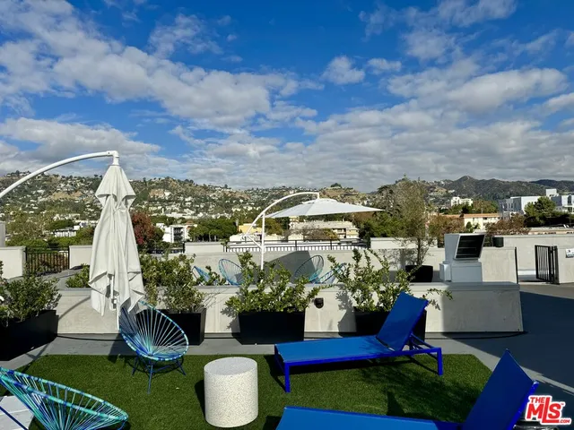 a view of a city with lawn chairs and a yard