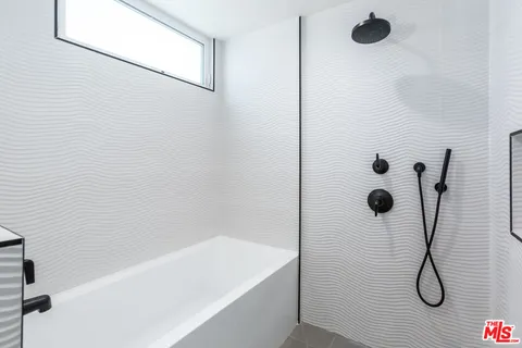 a bathroom with a shower and a bathtub
