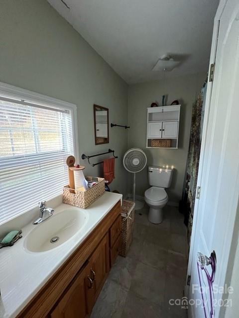 3229 Hiwassee Dam Access Road Murphy, NC 28906 - Photo 16 of 20 a bathroom with a granite countertop toilet sink and mirror