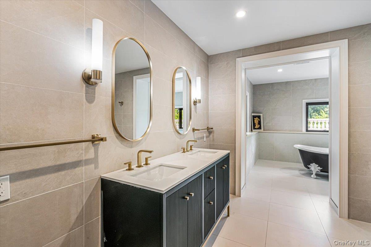 952 Cedar Swamp Road Glen Head, NY 11545 - Photo 24 of 50 a bathroom with a sink and a mirror