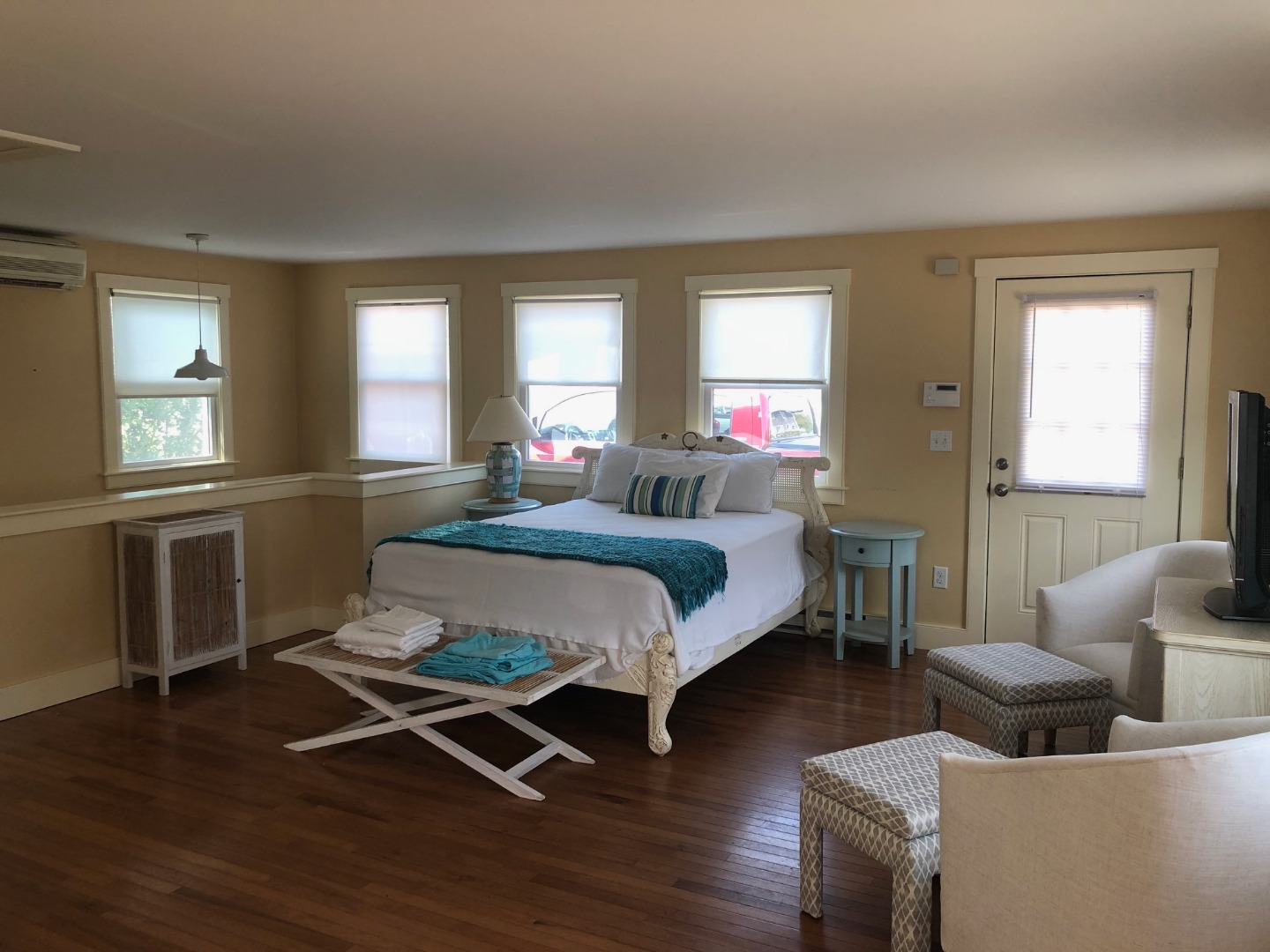 3 A Sun Island Road, Unit 4 Nantucket, MA 02554 - Photo 3 of 17 a bedroom with a bed wooden floor and windows