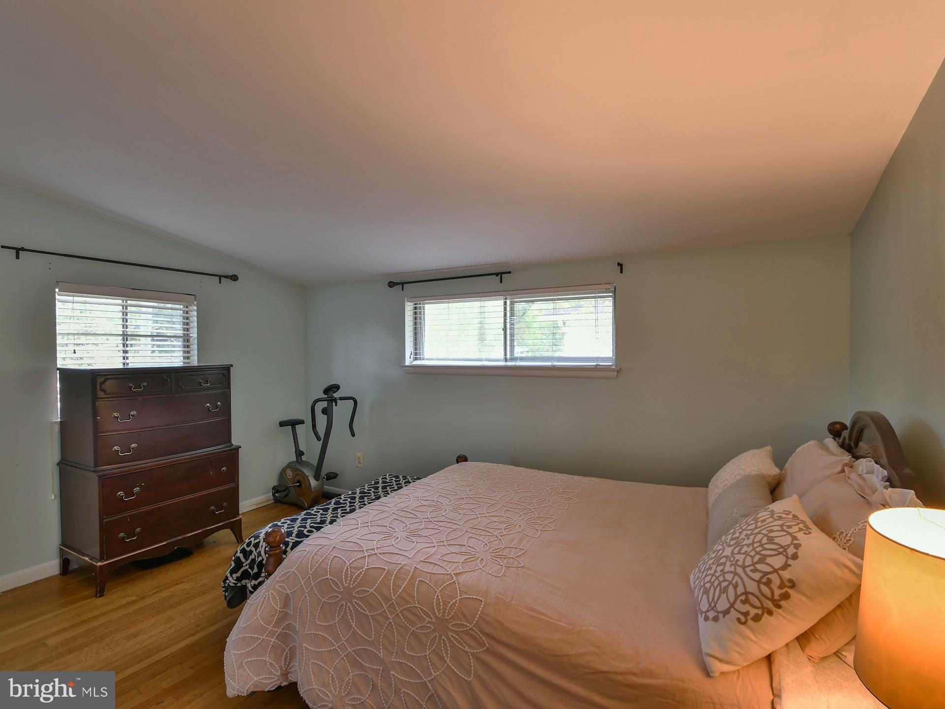 907 North Belgrade Road Silver Spring, MD 20902 - Photo 14 of 23 a bedroom with a bed and wooden floor