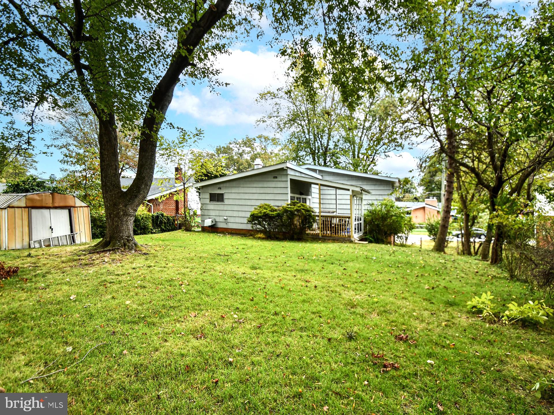 907 North Belgrade Road Silver Spring, MD 20902 - Photo 23 of 23 a yellow house sitting in middle of forest