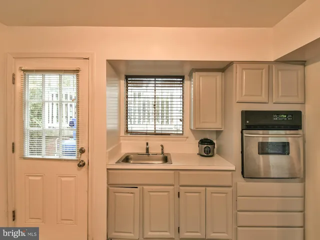 a kitchen with stainless steel appliances a sink stove and cabinets