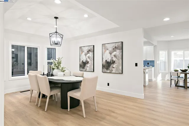a view of a dining room with furniture wooden floor and chandelier