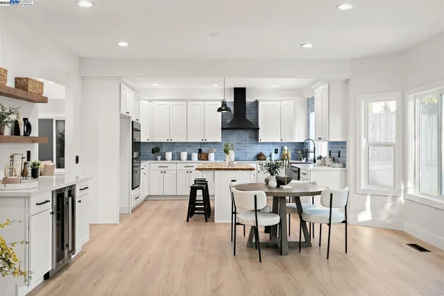 a kitchen with a cabinets and wooden floor