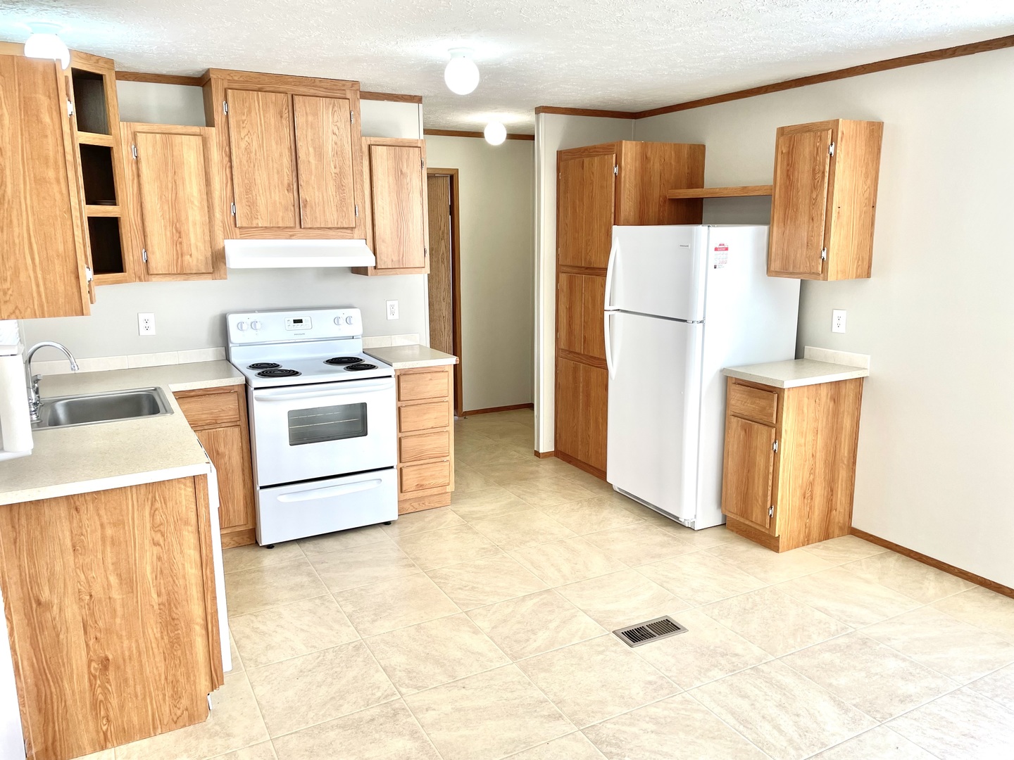 238 Northshore Road Elgin, IL 60123 - Photo 3 of 16 a kitchen with a stove a refrigerator and a sink