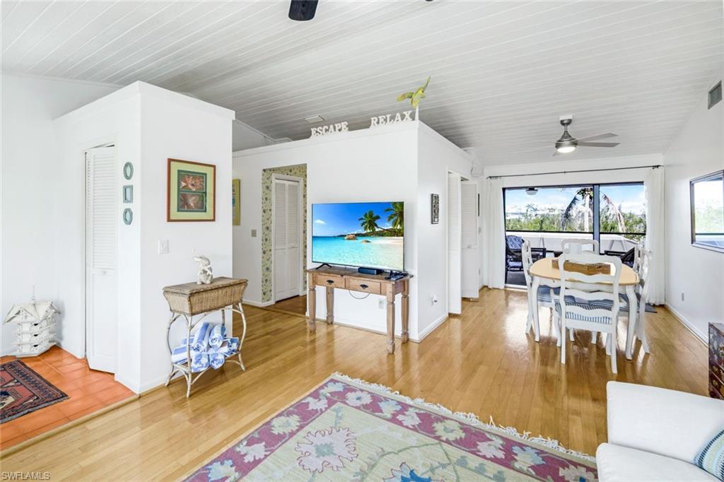 647 Rabbit Road Sanibel, FL 33957 - Photo 12 of 46 a living room with fireplace furniture and a wooden floor