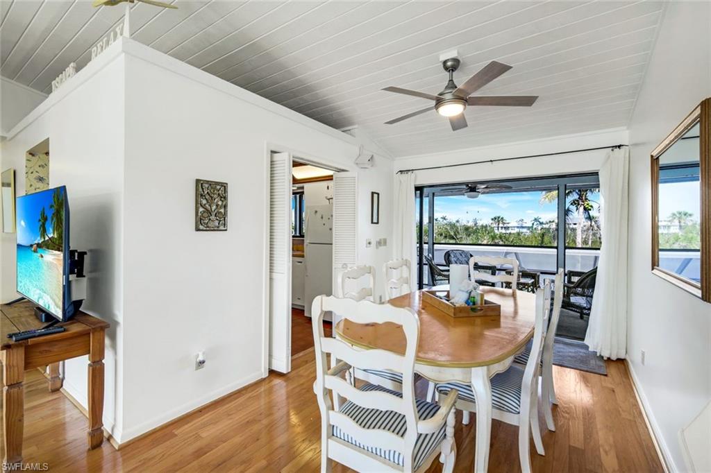 647 Rabbit Road Sanibel, FL 33957 - Photo 13 of 46 a dining room with furniture a window and wooden floor