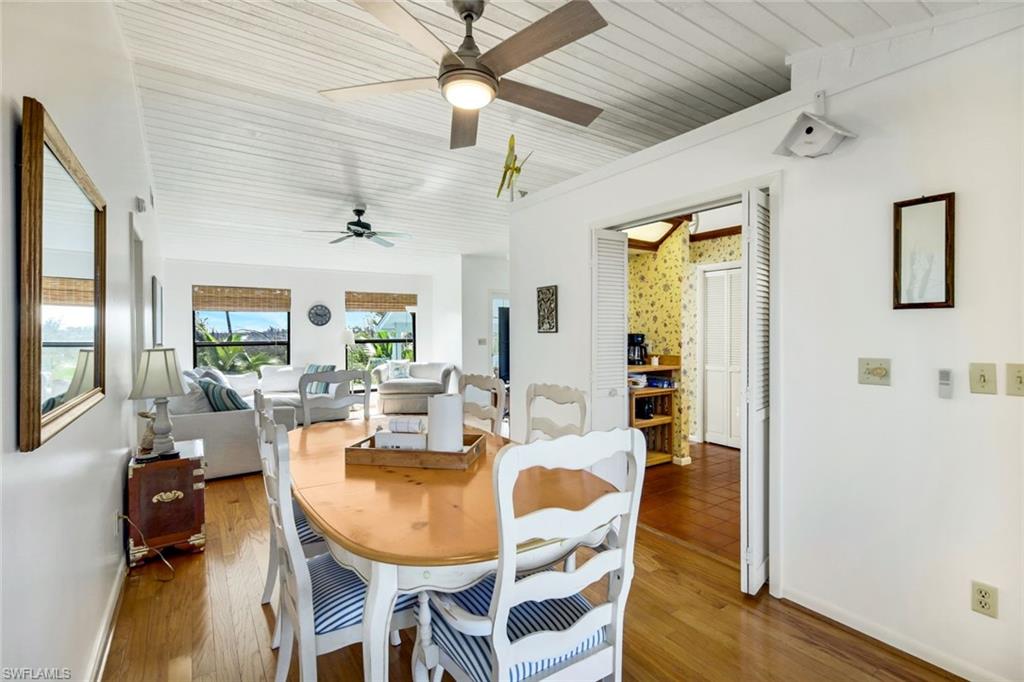647 Rabbit Road Sanibel, FL 33957 - Photo 14 of 46 a view of a dining room with furniture and wooden floor