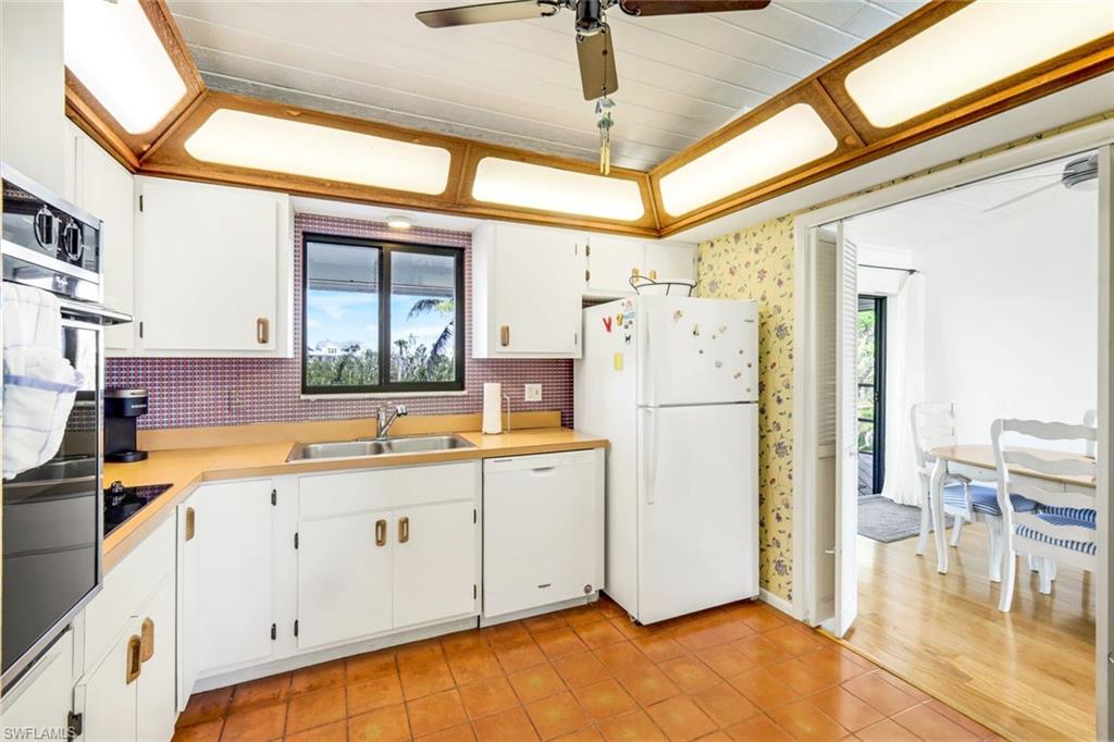 647 Rabbit Road Sanibel, FL 33957 - Photo 15 of 46 a kitchen with stainless steel appliances a refrigerator and a stove