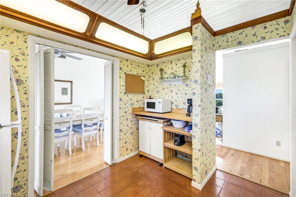 647 Rabbit Road Sanibel, FL 33957 - Photo 17 of 46 a view of a hallway with a dining table & chairs