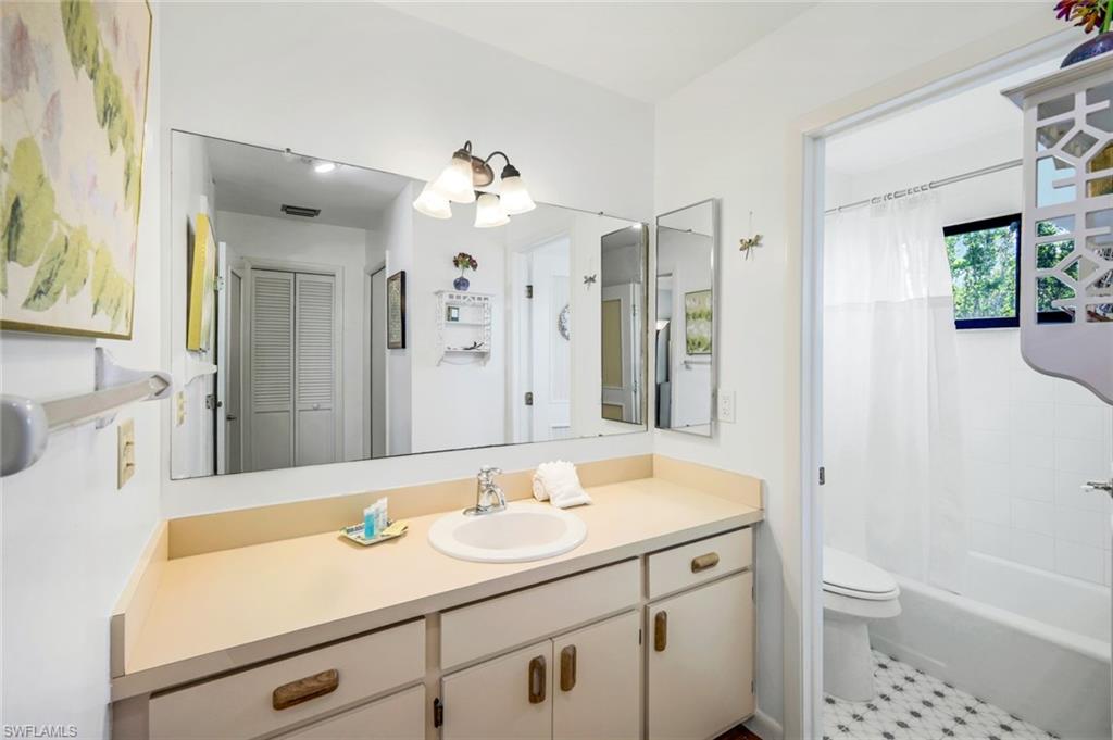 647 Rabbit Road Sanibel, FL 33957 - Photo 21 of 46 a bathroom with a sink a toilet a mirror and shower