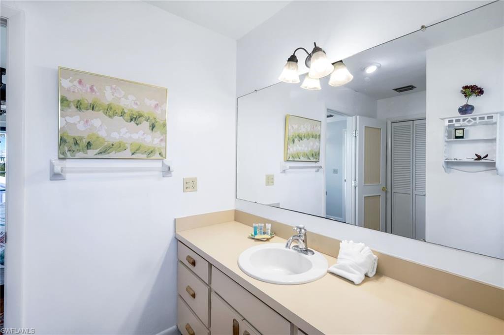 647 Rabbit Road Sanibel, FL 33957 - Photo 22 of 46 a bathroom with a granite countertop sink and a mirror