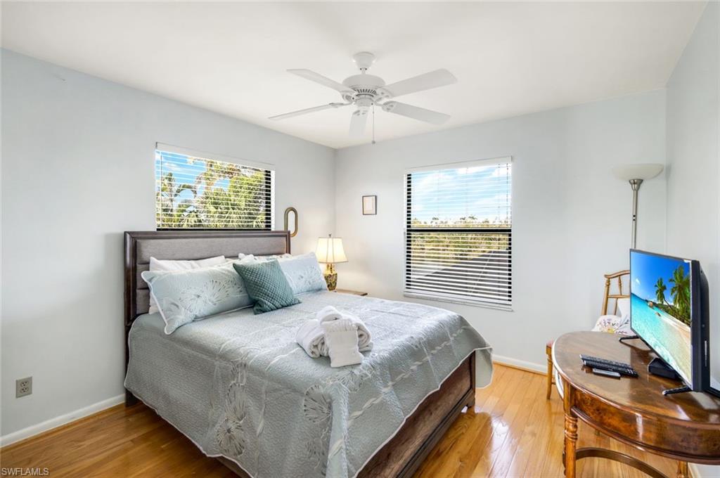 647 Rabbit Road Sanibel, FL 33957 - Photo 23 of 46 a bedroom with a bed and a flat screen tv