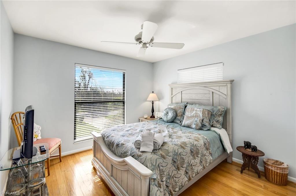 647 Rabbit Road Sanibel, FL 33957 - Photo 25 of 46 a bedroom with a bed and a flat tv screen on the dresser