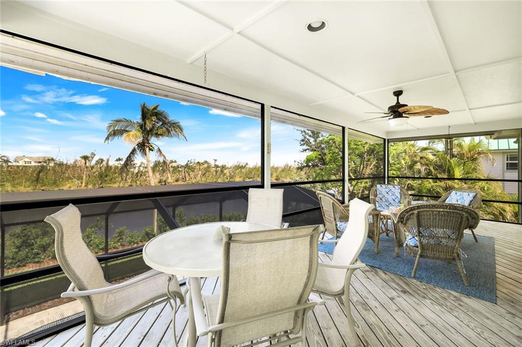 647 Rabbit Road Sanibel, FL 33957 - Photo 30 of 46 a view of a dining room with furniture large windows and wooden floor