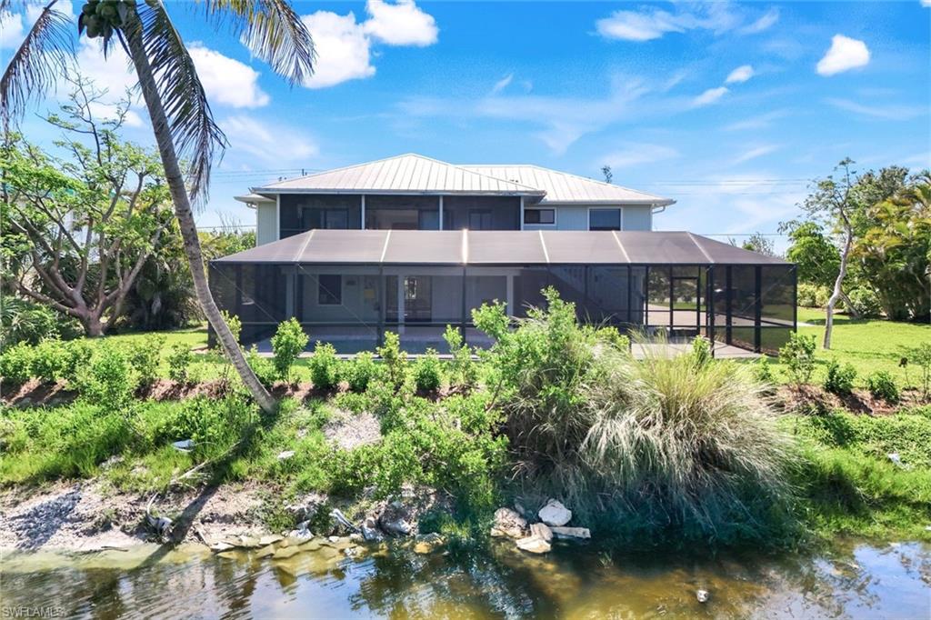 647 Rabbit Road Sanibel, FL 33957 - Photo 39 of 46 a view of a house with a yard and garden