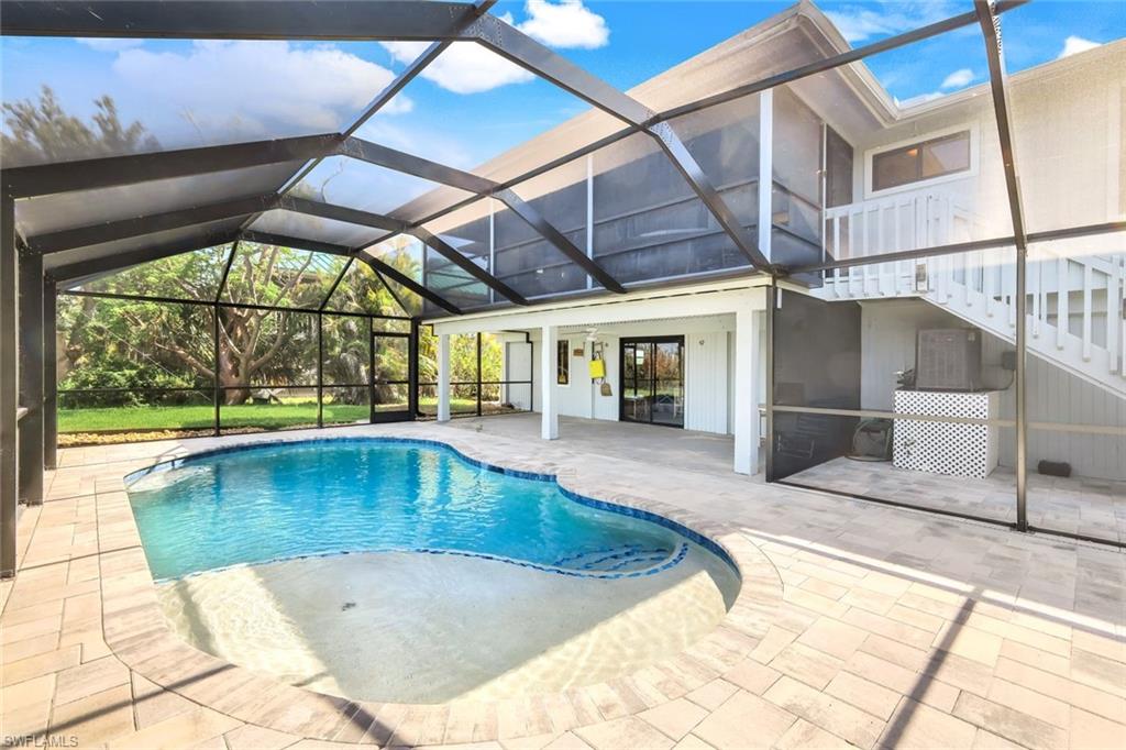 647 Rabbit Road Sanibel, FL 33957 - Photo 6 of 46 a view of a swimming pool with a patio