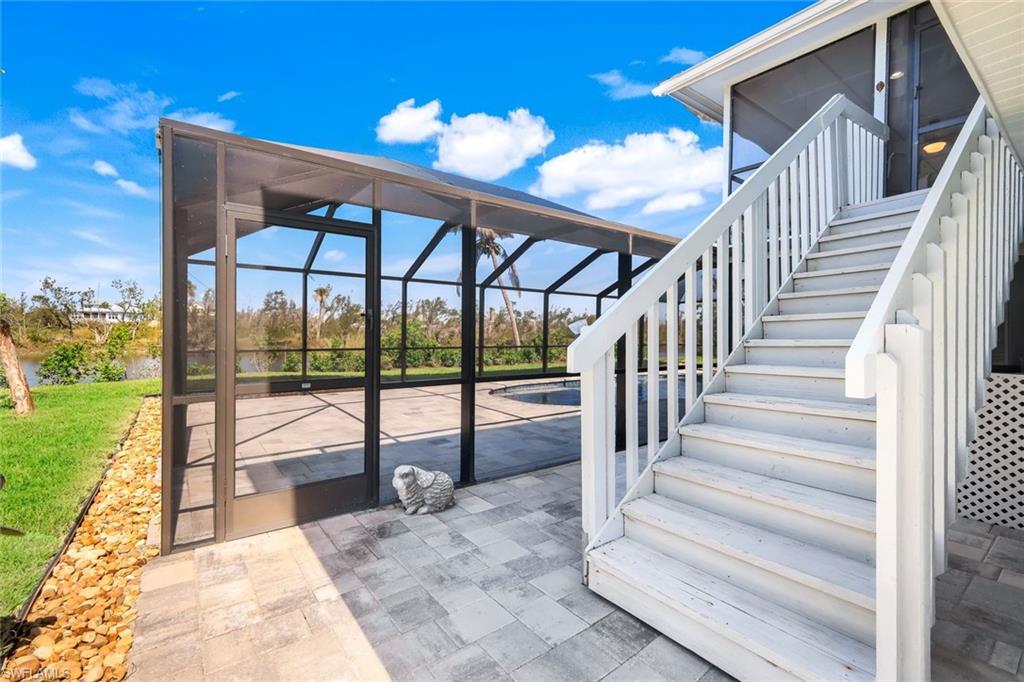 647 Rabbit Road Sanibel, FL 33957 - Photo 9 of 46 a view of staircase with a floor to ceiling window and stairs