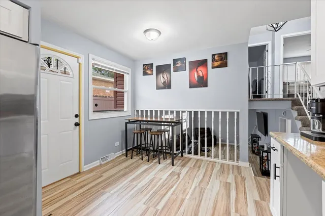 a view of a bedroom with wooden floor and a window