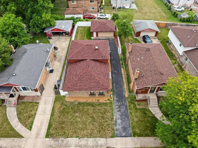 an aerial view of a house with a yard