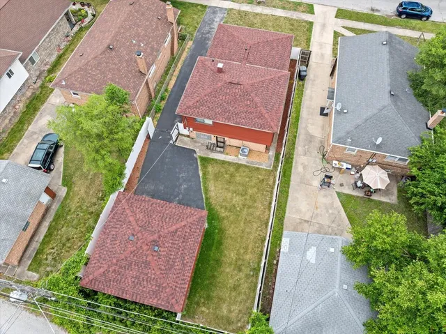 an aerial view of a house with a yard