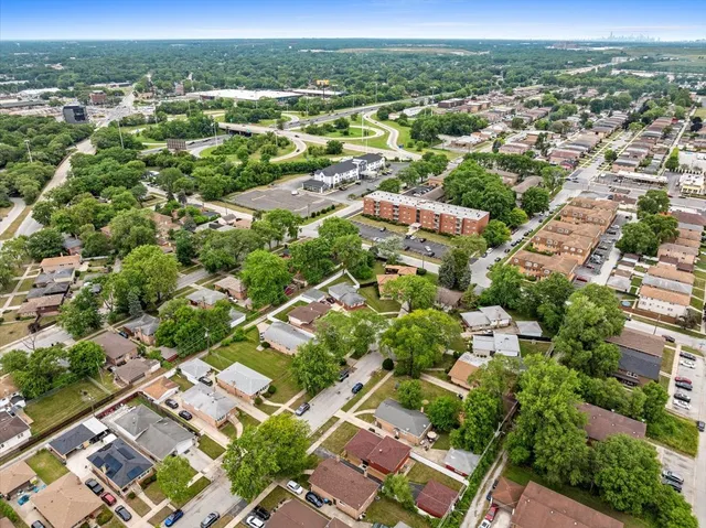 an aerial view of residential houses with outdoor space and street view