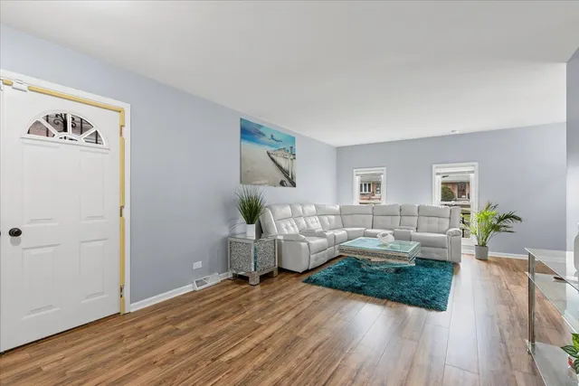 a bedroom with furniture and a wooden floor