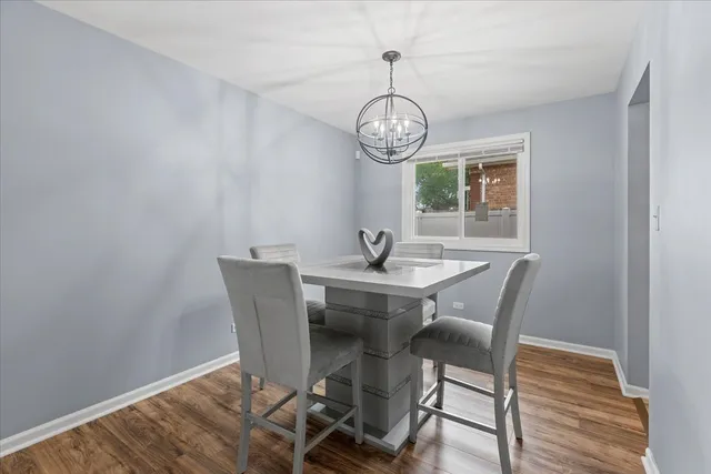 a view of a dining room with a table and chairs