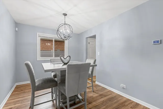 a view of a dining room with furniture wooden floor and chandelier