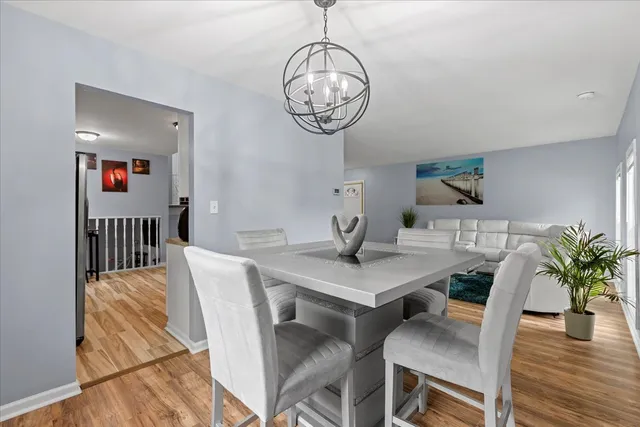 a view of a dining room with furniture wooden floor and a chandelier
