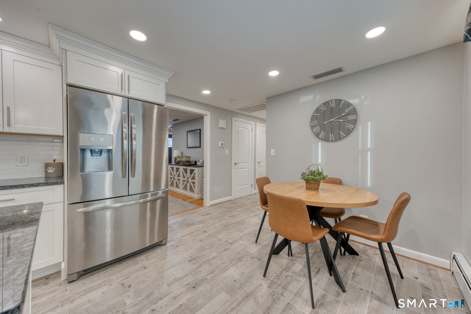 42 Northbrick Lane Wethersfield, CT 06109 - Photo 20 of 37 a kitchen with stainless steel appliances granite countertop a dining table and chairs